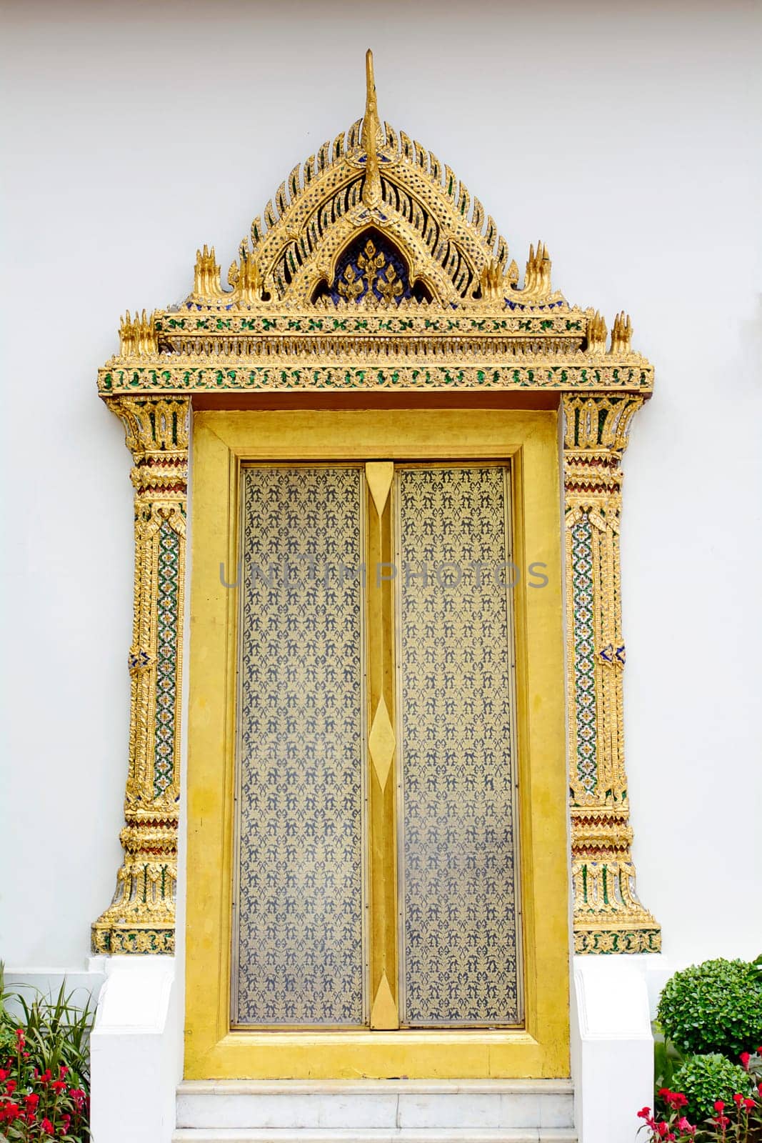 Wat Phra Kaew OR "Temple of the Emerald Buddha""  full official name Wat Phra Si Rattana Satsadaram is Buddhist temple (wat) in Thailand. The main building is the central phra ubosot, which houses the statue of the Emerald Buddha. Wat Phra Kaeo has a plethora of buildings within the precincts of the Grand Palace. It is located in Phra Nakhon District, the historic centre of Bangkok."