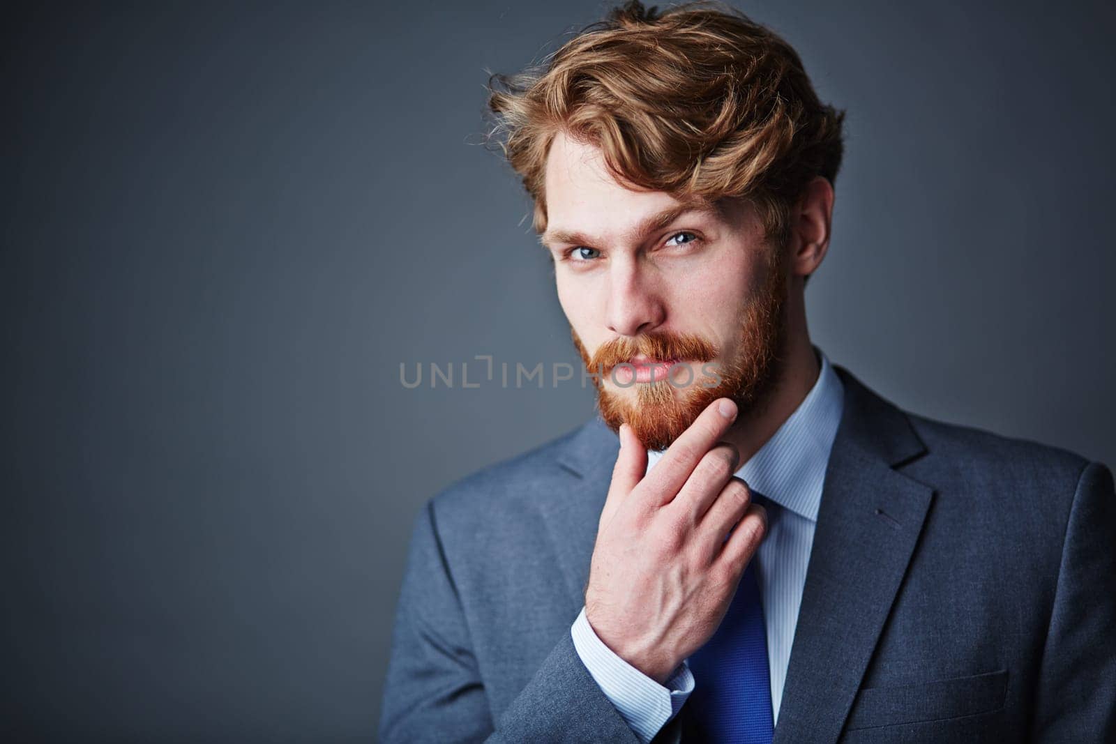 Confident businessman with beard looking at camera