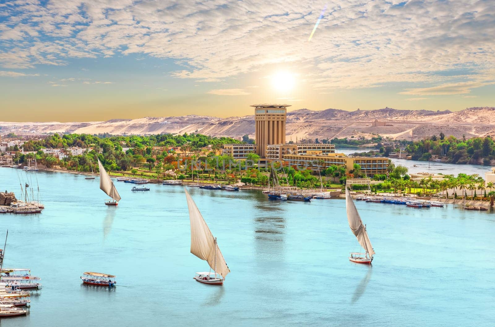 Sailboats of the Nile, beautiful sunset over Aswan city, Egypt.