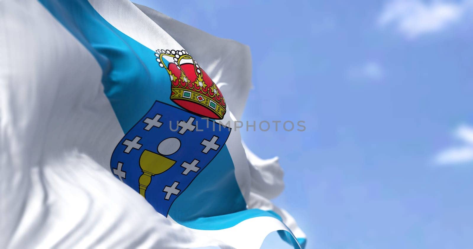 The Extremadura flag waving in the wind on a clear day. The Extremadura is an autonomous community of Spain. Its capital city is Merida