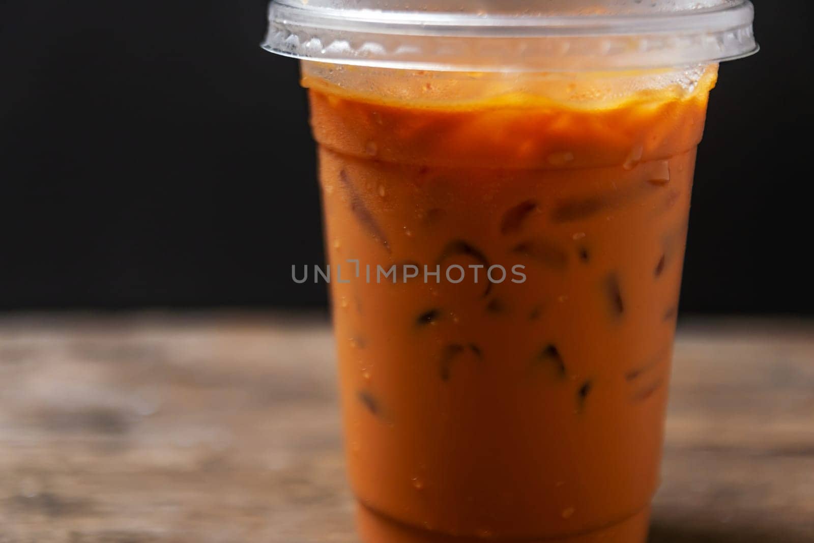 Tea thai, Ice tea milk or Ice milk tea, Sweet drink, Blurred black background