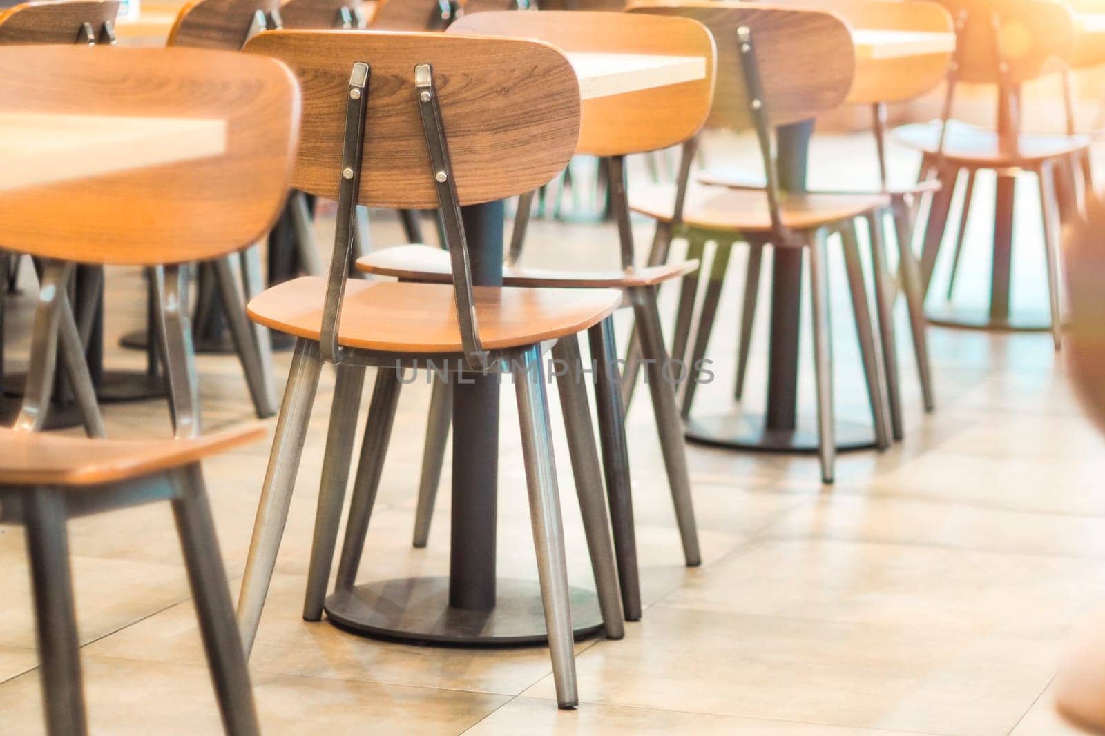 Morning light through rows of  Empty table and chairs in cafe restaurant