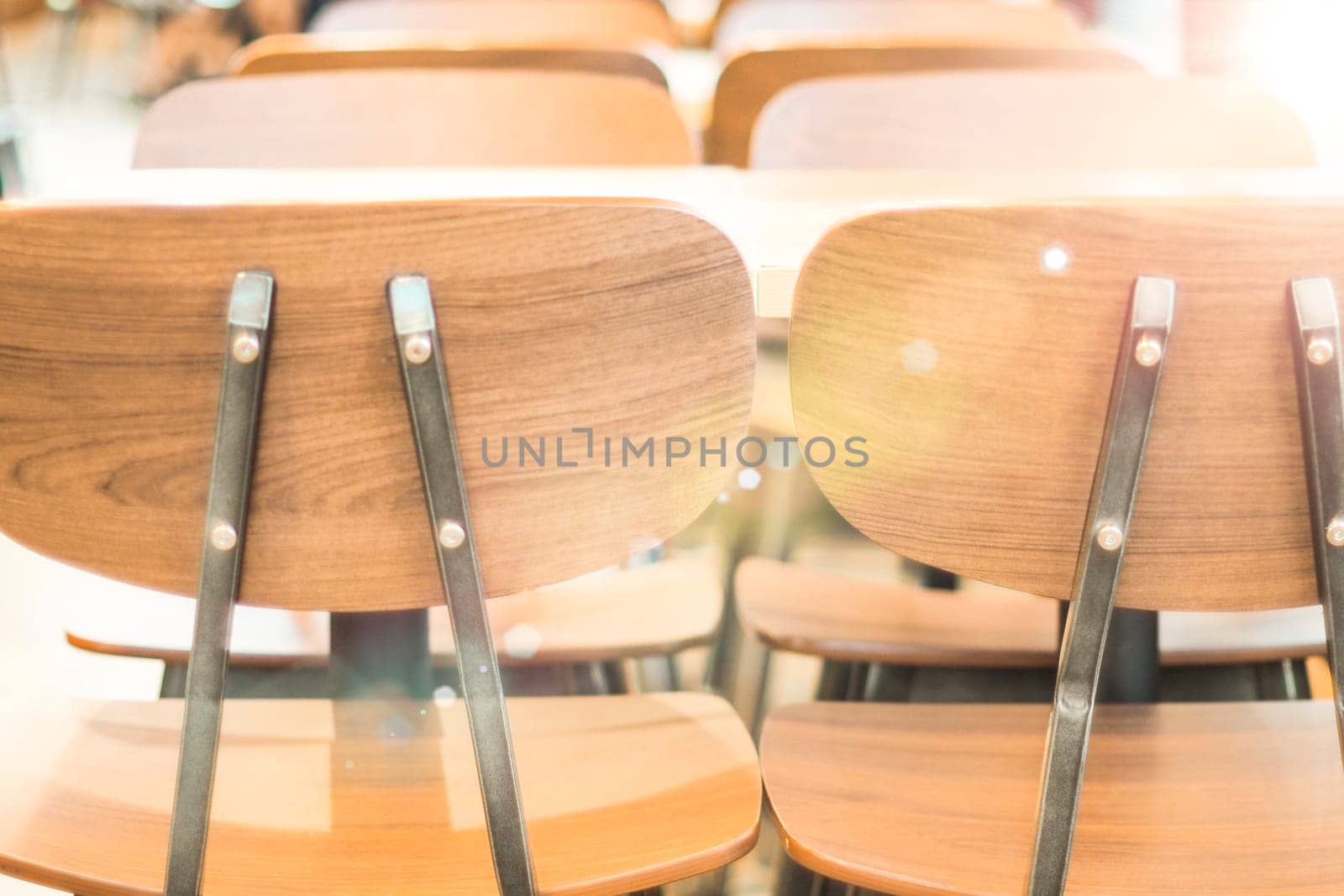 Morning light through rows of  Empty table and chairs in cafe restaurant