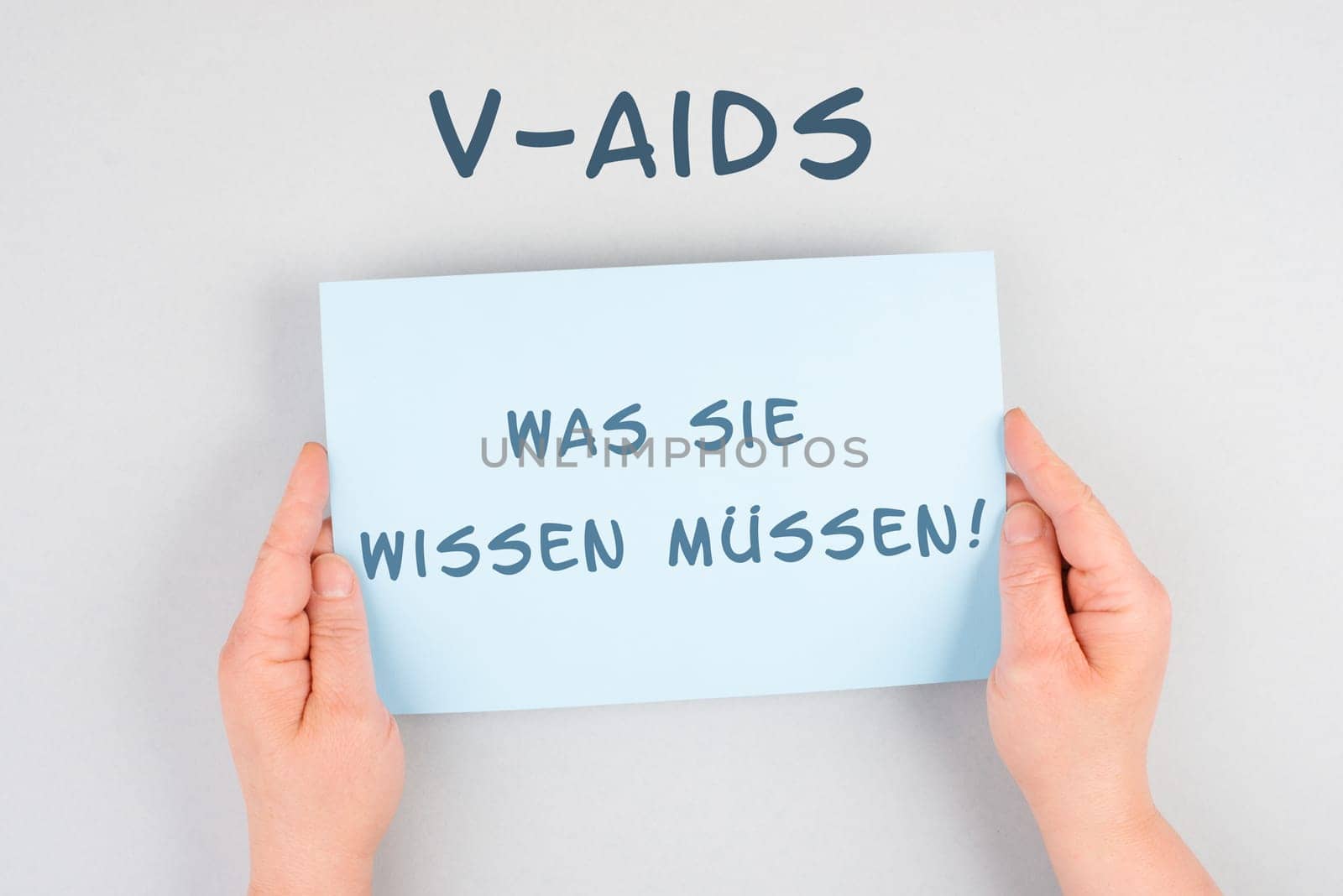 The words v-aids, what you need to know are standing in german language on a paper, new autoimmune disease caused by covid-19 vaccination, immune system damage, health issue