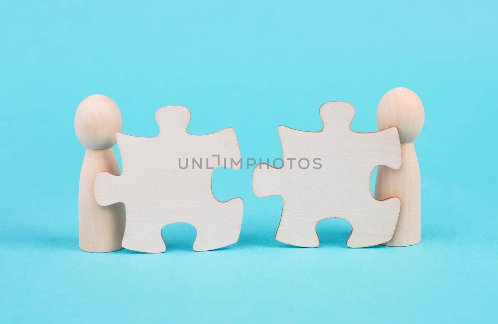 Two men with puzzle pieces built a team, connect the parts together, corporate in teamwork, communication and support concept