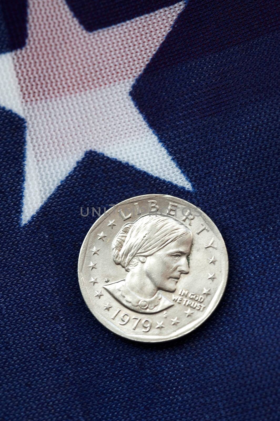 one dollar coin on american flag