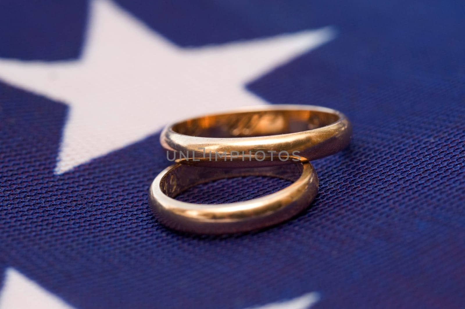 two gold wedding rings on a colored background