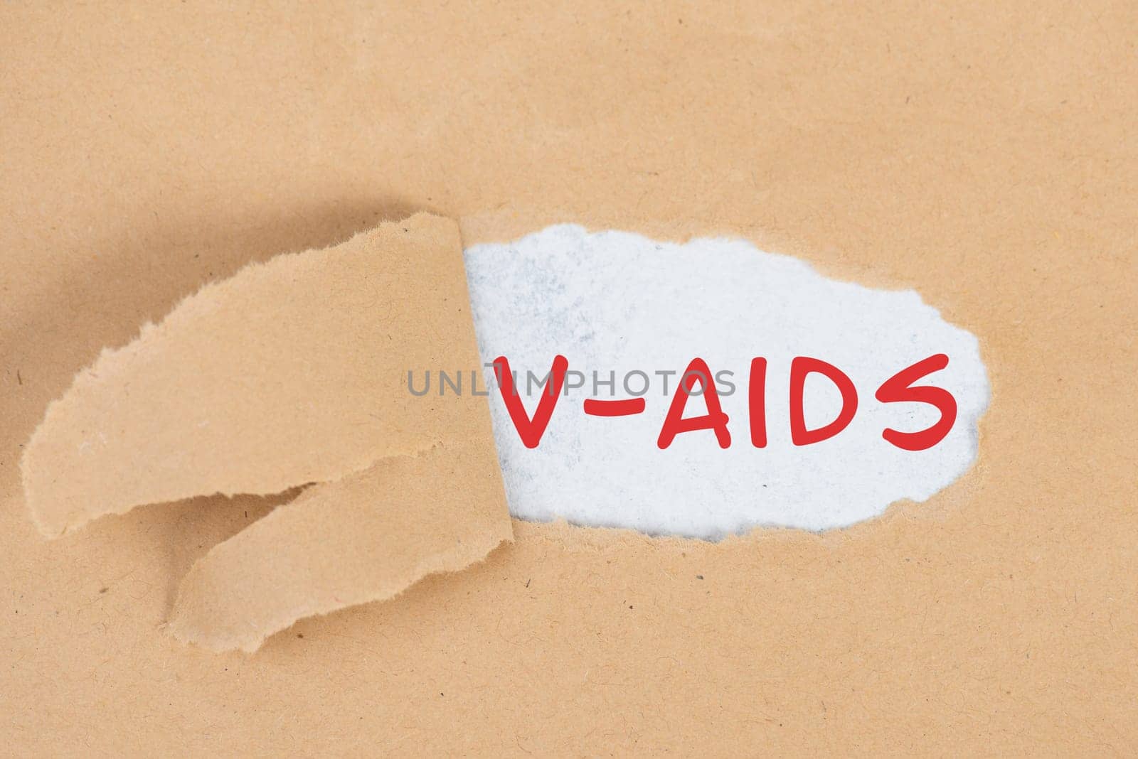 The words v-aids is standing in german language on on torn paper, vaccine damage, new autoimmune disease caused by covid-19 syringe, immune system injury, health issue