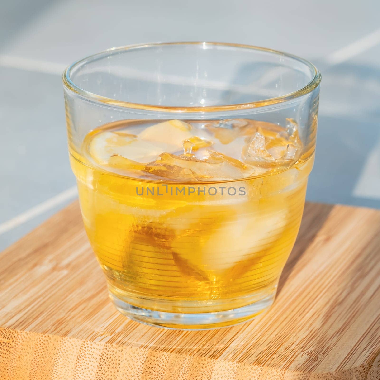 Glass of golden rum on the rocks