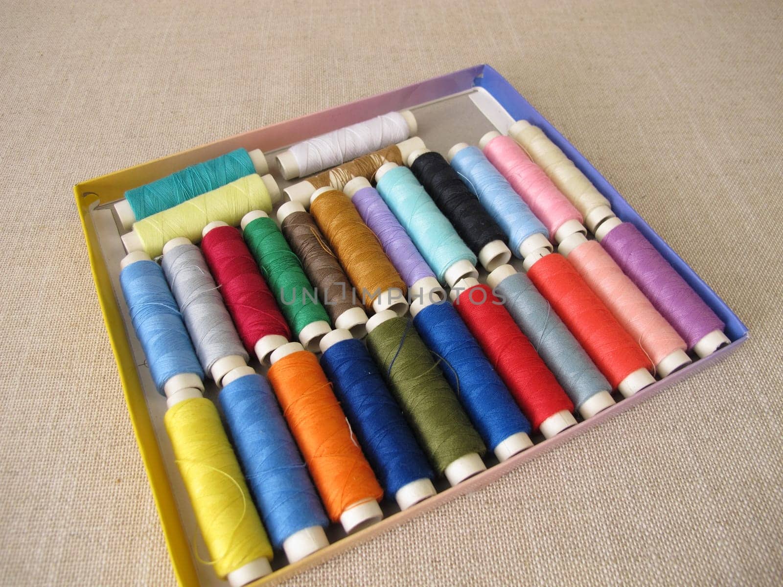 Sewing thread in different colors in a box