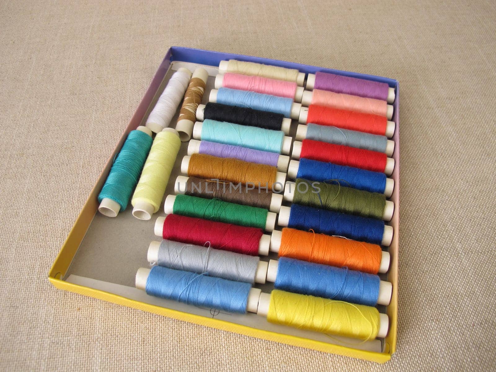 Sewing thread in different colors in a box