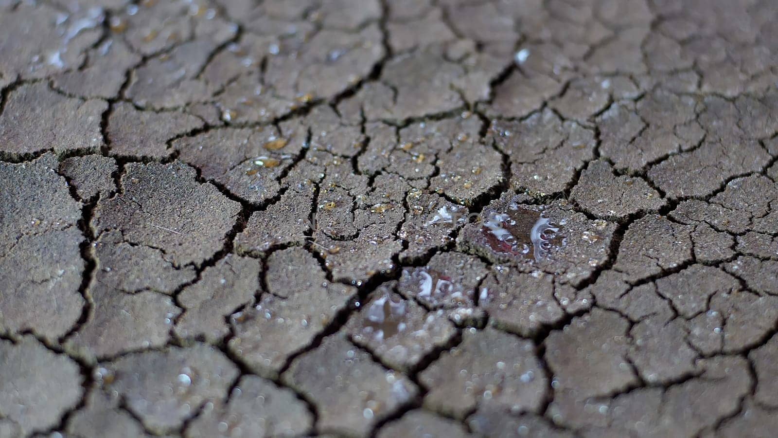 Water Drops Fall On Dry Fractured Soil Of Drought,Water Drops Fall On Dry Fractured Soil Of Drought