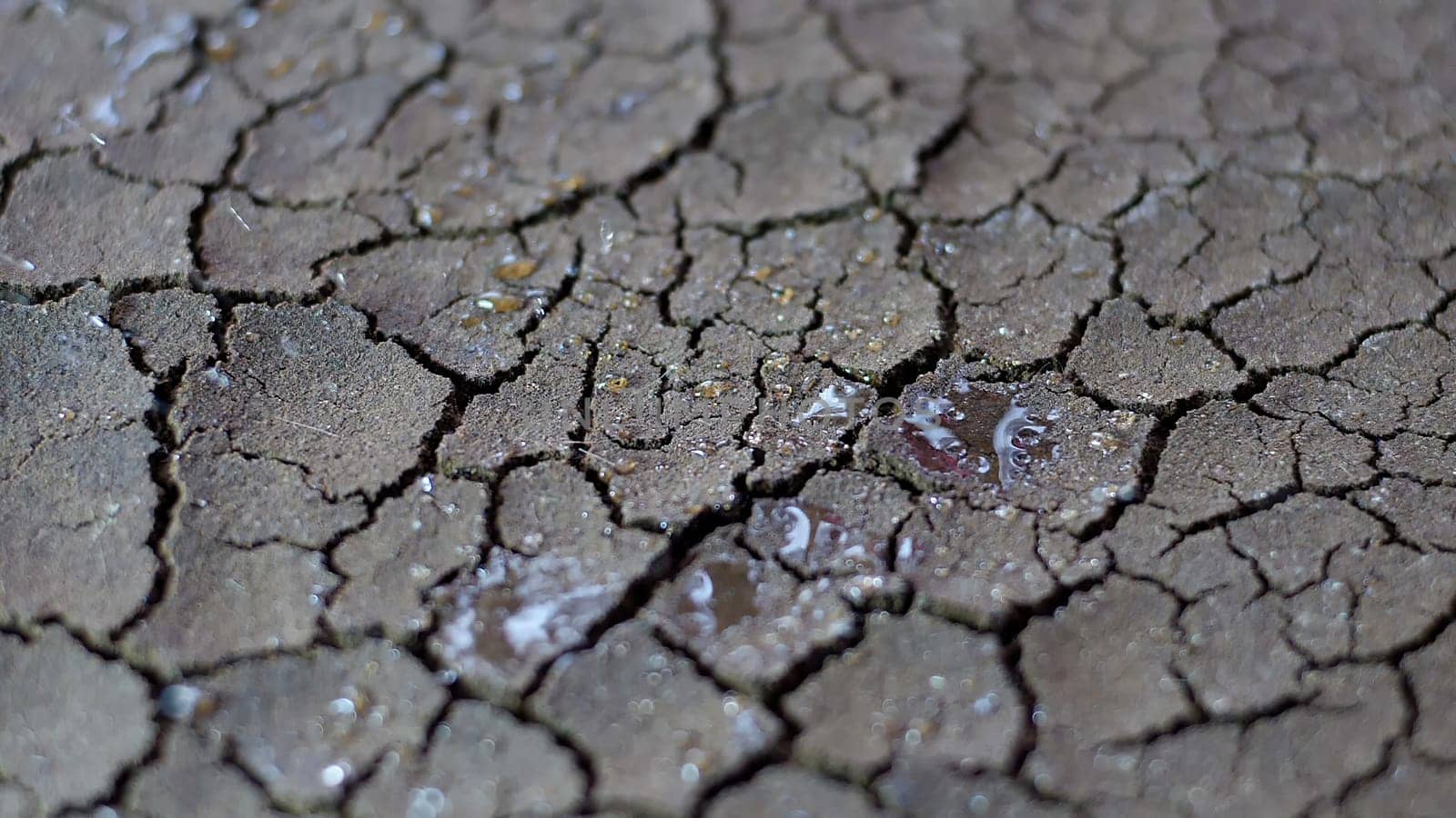 Water Drops Fall On Dry Fractured Soil Of Drought,Water Drops Fall On Dry Fractured Soil Of Drought
