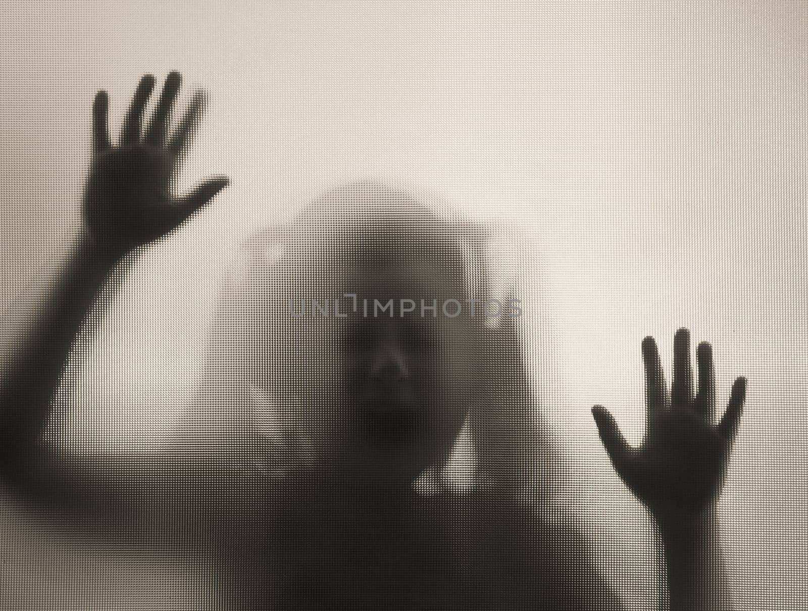 Horror ghost girl behind the matte glass in black and white. Halloween festival concept.