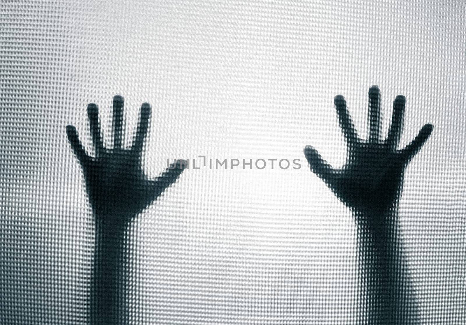 Horror, halloween background - Shadowy figure hands behind glass