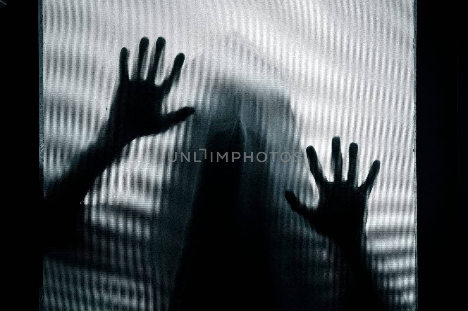 Horror, halloween background - Shadowy figure behind glass