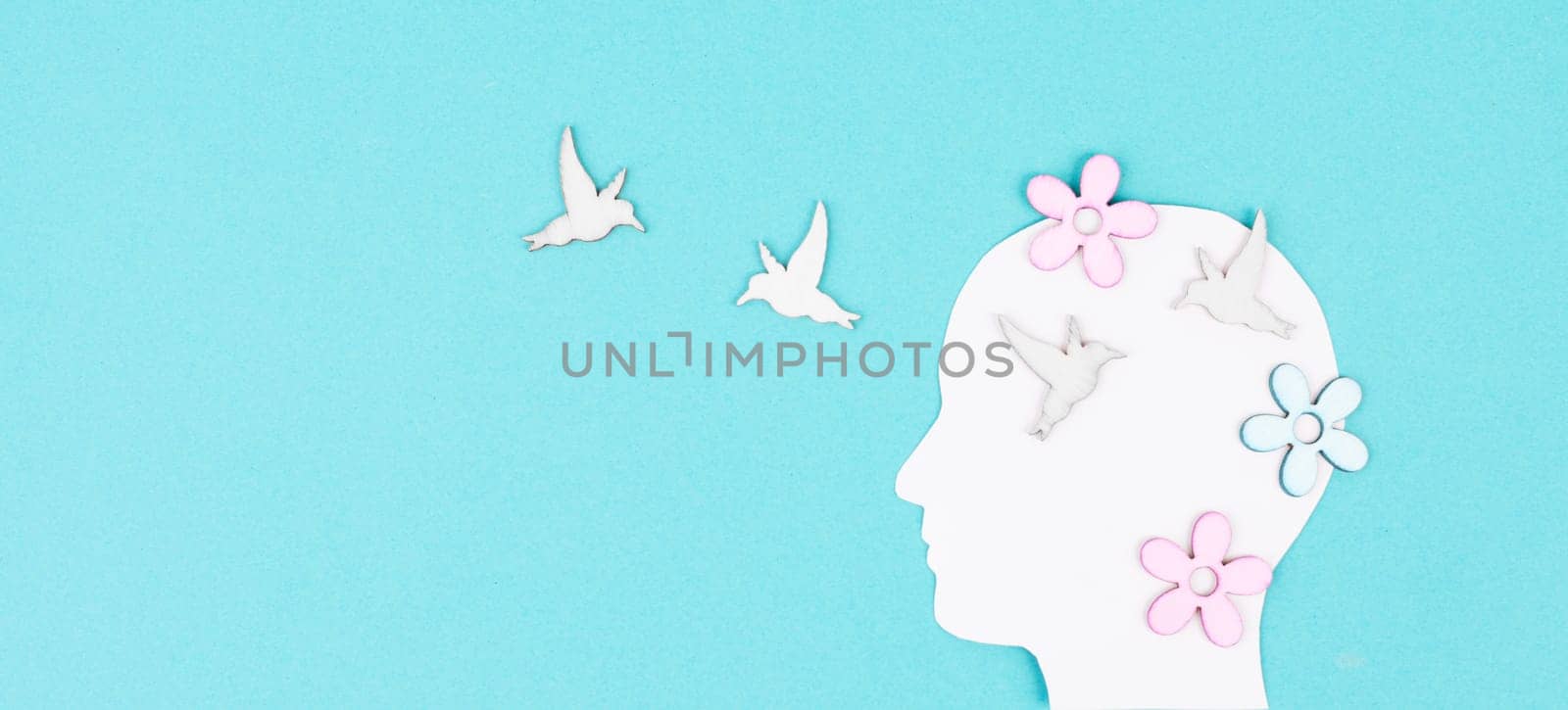 Silhouette of a woman with birds and flowers, greeting card with copy space, open mindset, creative portrait