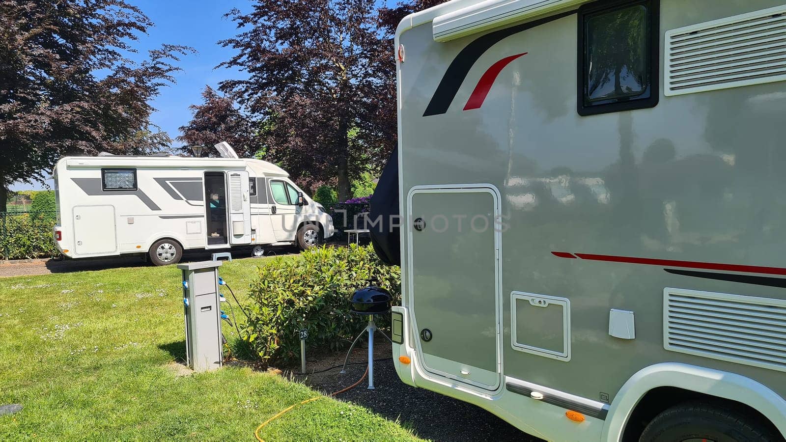 Campers parked on a Camer Van pitch. Concept camper van leisure and fun