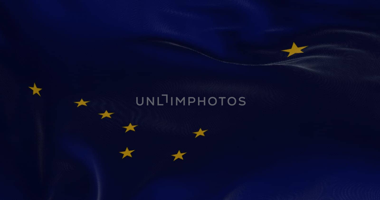 The state flag of Alaska waving in the wind. Democracy and independence. American state.