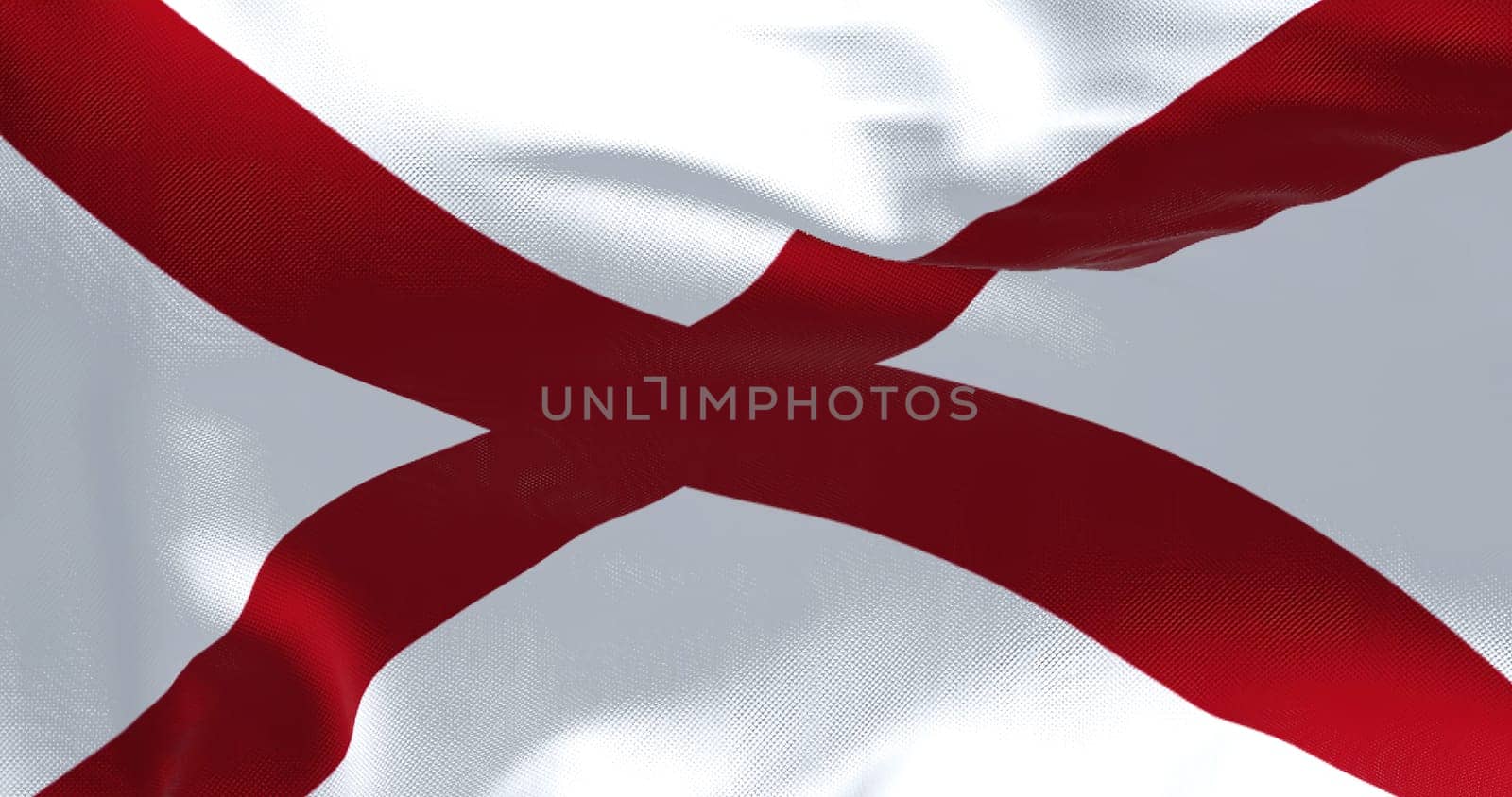 Close up of the Alabama state flag waving in the wind. Alabama is a state in the Southeastern region of the United States. Democracy and independence. American state.