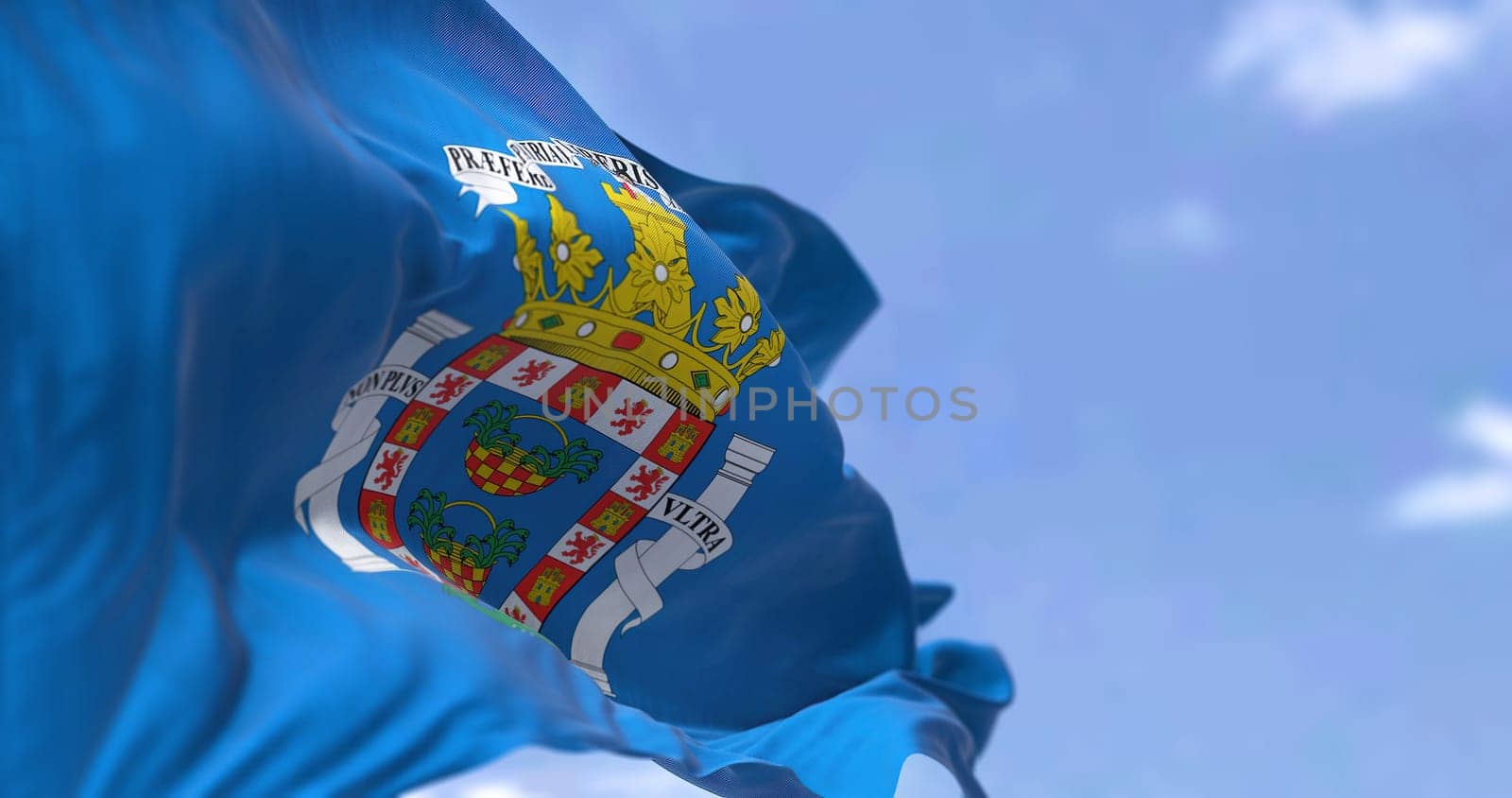 Rear view of Mellla city flag waving in the wind on a clear day. Melilla is one of two autonomous cities of Spain, located in north Africa country. Selective focus