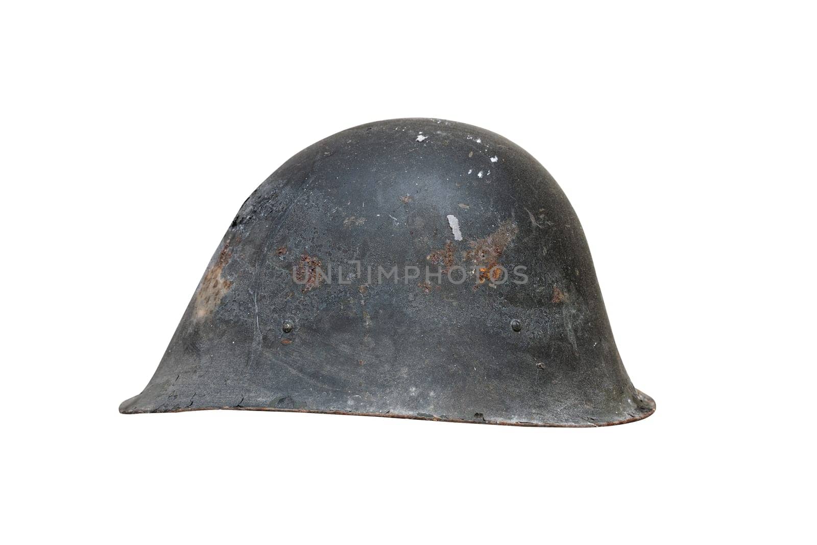 side view closeup of old black Second World War rusted metal helmet with traces of rust and cracks isolated on white background