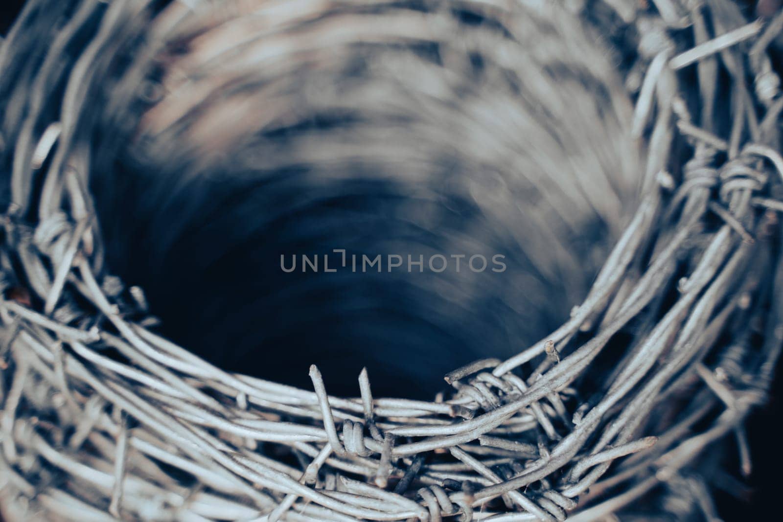 macro closeup of large roll of steel barbed wire used for fence construction