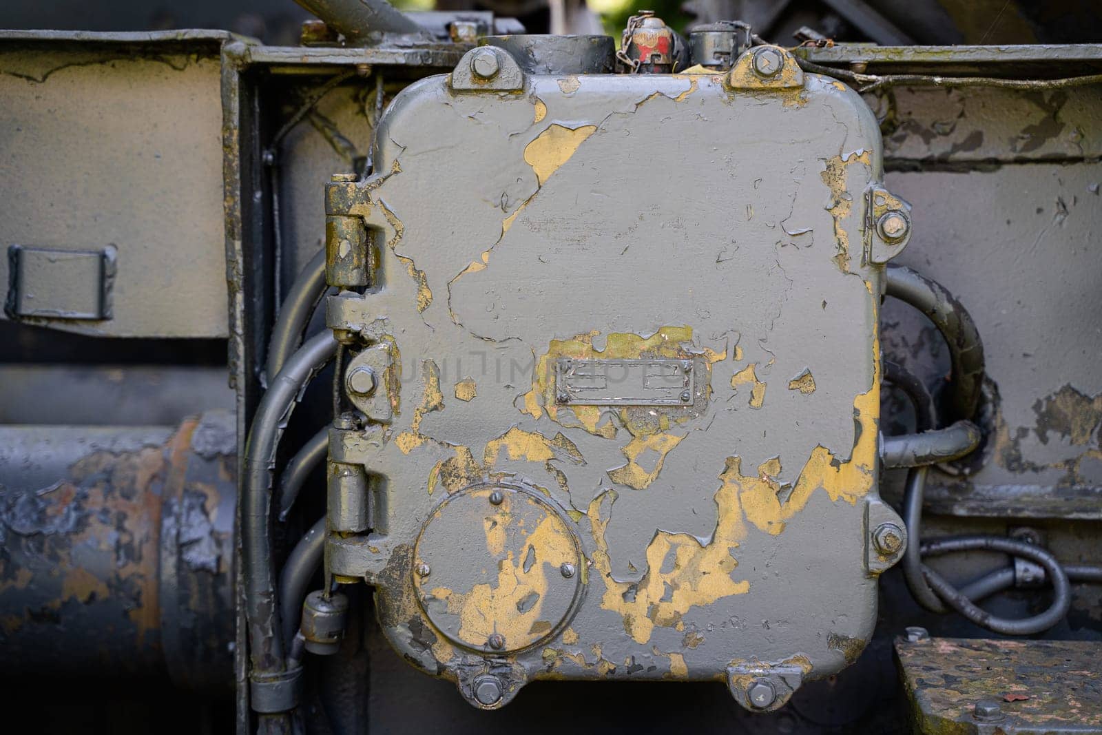 front view closeup of rusted metallic cabinet panel enclosure with peeled off paint