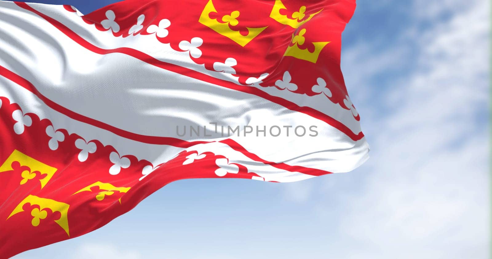 View of the Alsace flag waving in the wind on a clear day. Alsace is a cultural region and a territorial collectivity in eastern France. Selective focus