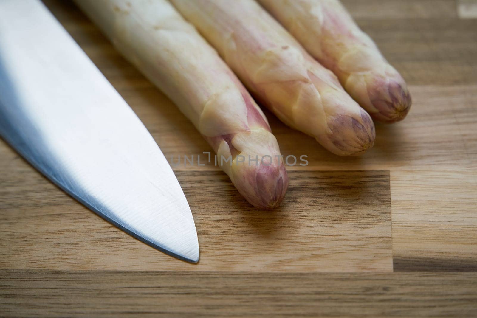 Fresh white asparagus directly from the field on a kitchen table