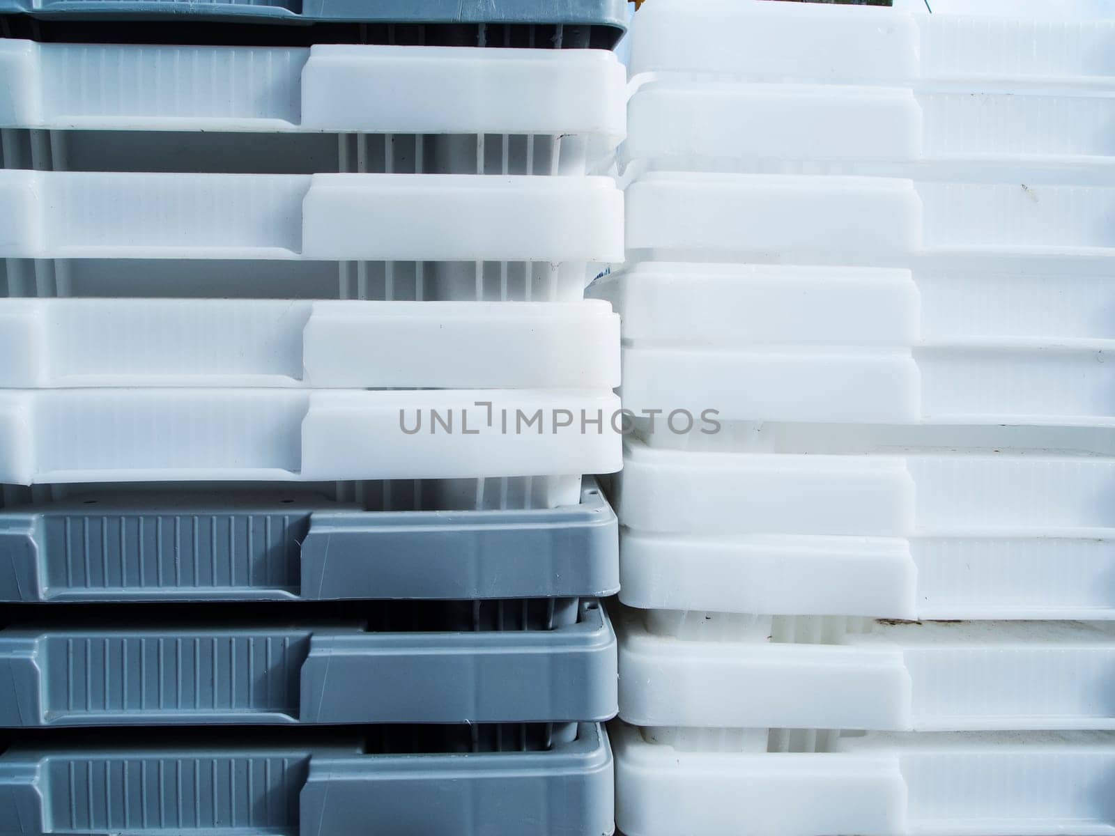 Close-up view of white and gray plastic containers stacked inside.