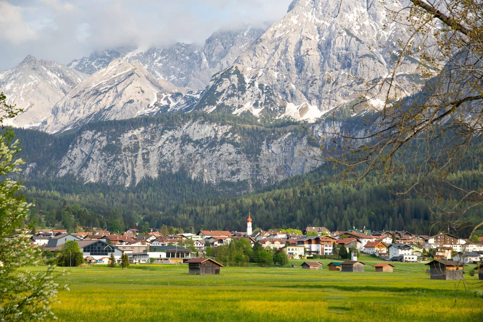 Small village in Austria with the Alps mountains in the background.