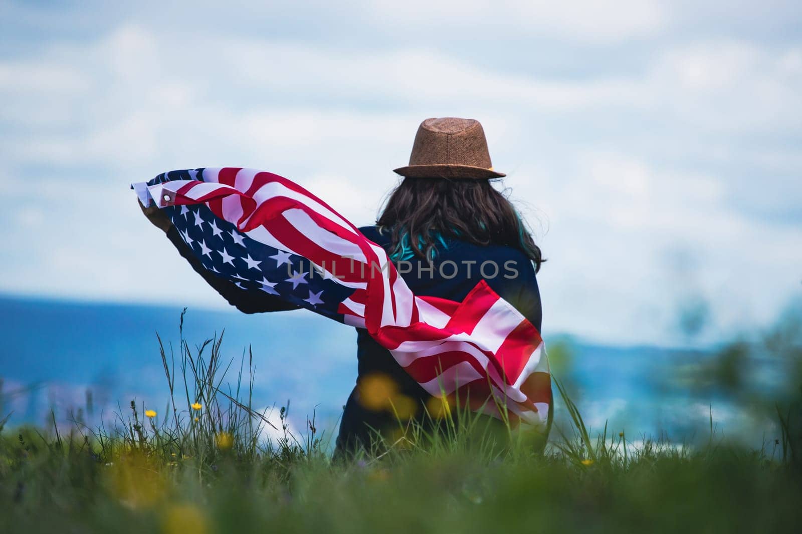 Young woman holding american USA flag. Independence Day or traveling in America concept.