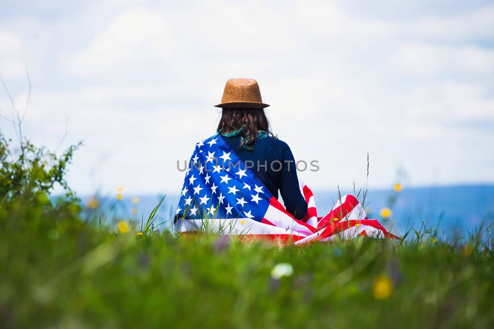 Young woman holding american USA flag. Independence Day or traveling in America concept.