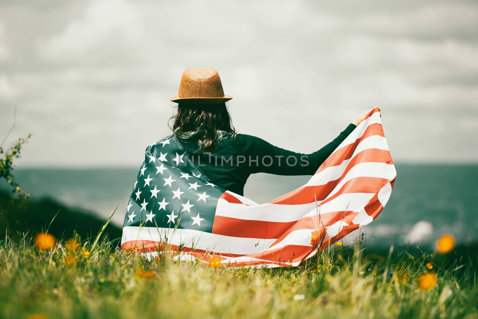 Young woman holding american USA flag. Independence Day or traveling in America concept.