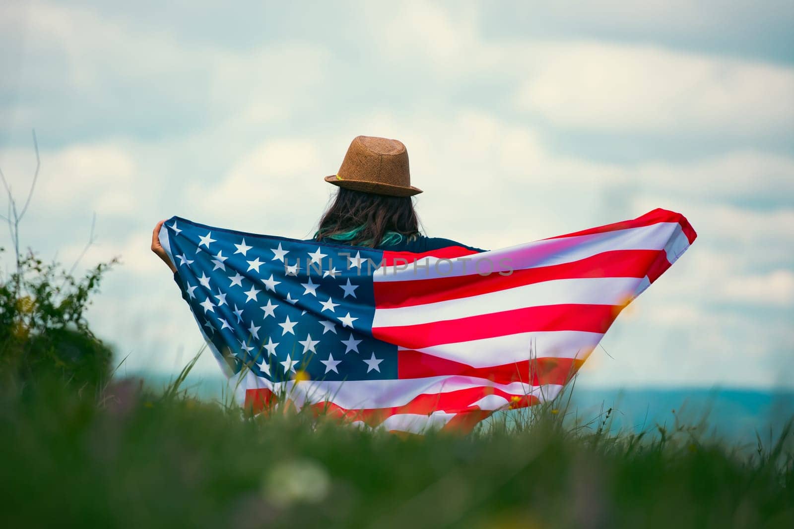 Young woman holding american USA flag. Independence Day or traveling in America concept.