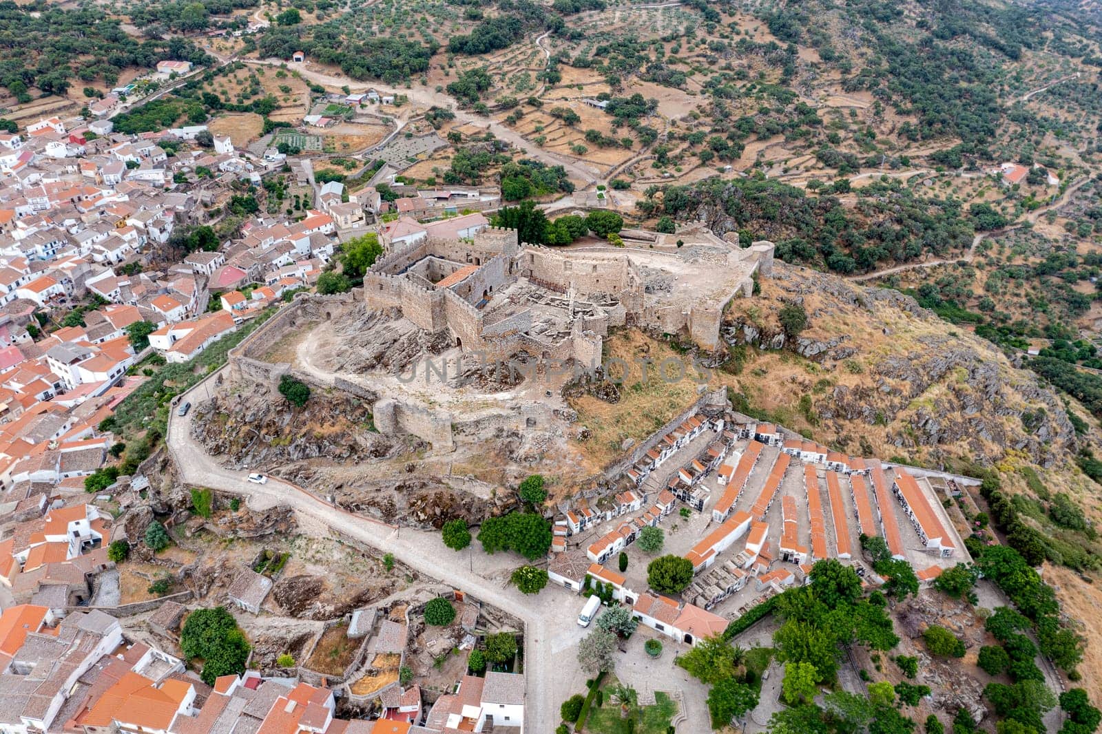 The ancient castle of montanchez near Caceres, Extremadura, Spain, freely accessible to tourists, is situated on top of a mountain and offers a beautiful panoramic view of the landscape. Aerial view from above
