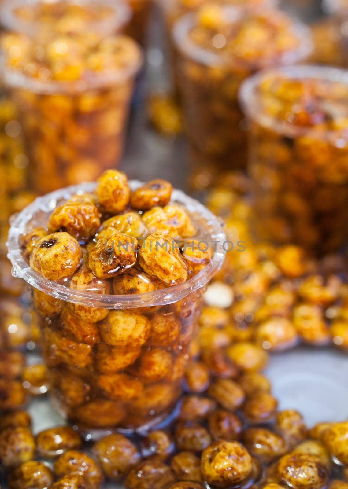 Glasses with tiger nuts or chufas. Water drops falling on cups displayed at street market stall