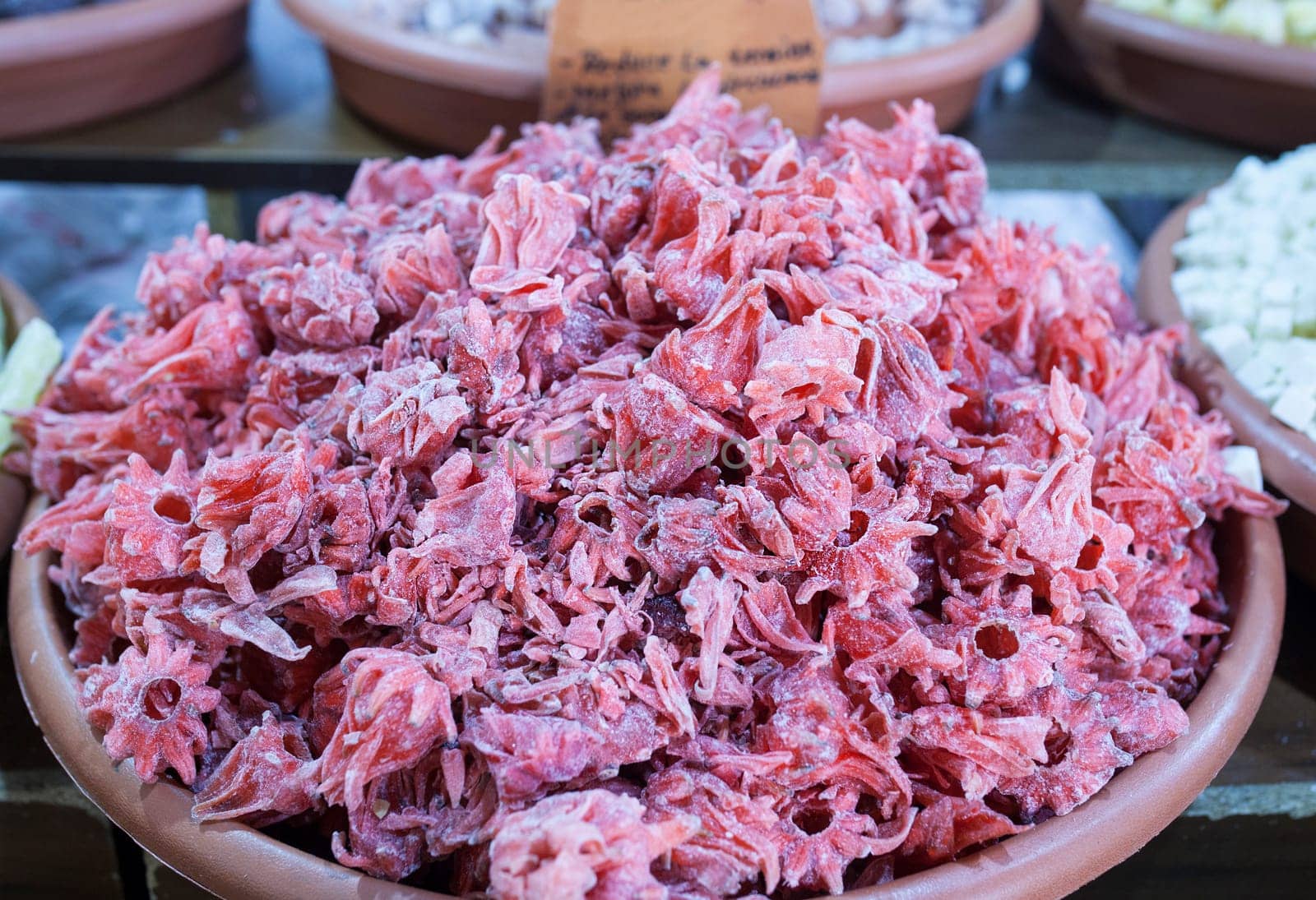 Dried hibiscus flowers. Slices displayed at street market stall
