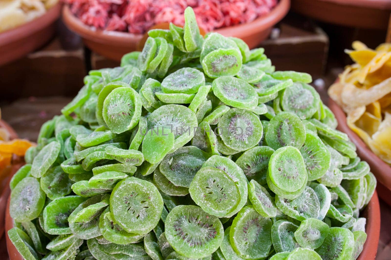 Bowl with dried kiwifruit. Slices displayed at street market stall