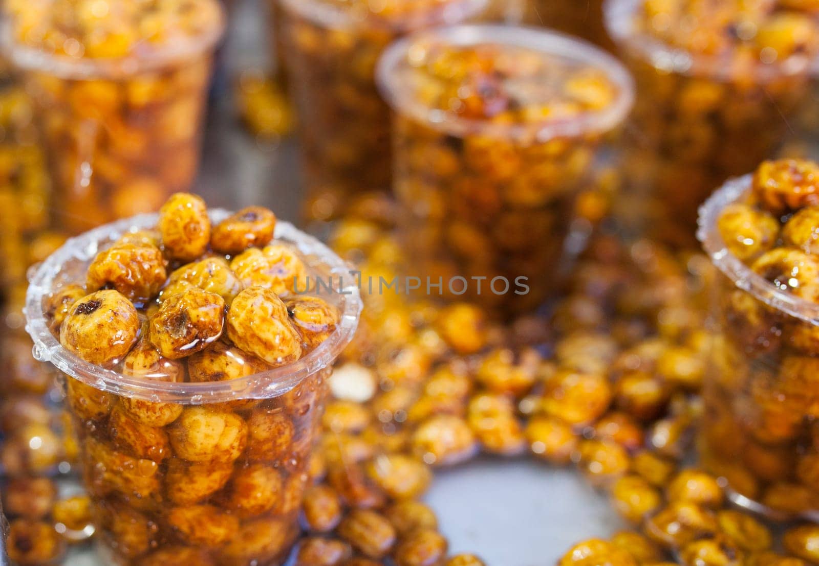 Glasses with tiger nuts or chufas. Water drops falling on cups displayed at street market stall