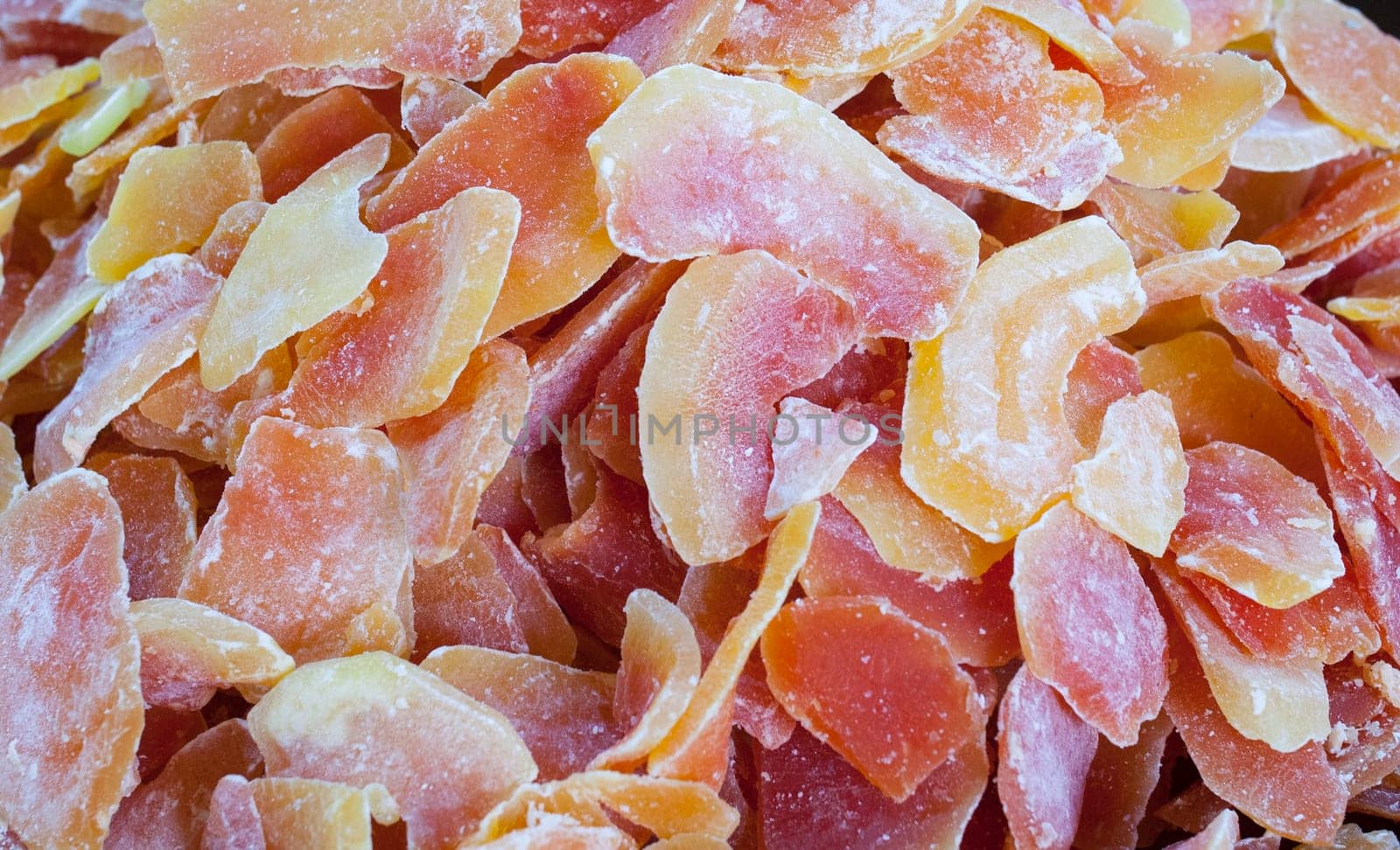 Bowl with dried papaya fruit. Slices displayed at street market stall