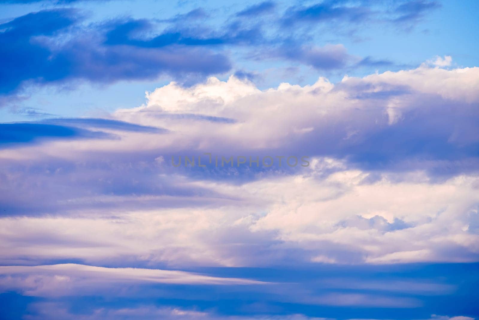 Beautiful evening sky with pink clouds. Sunset over the sea