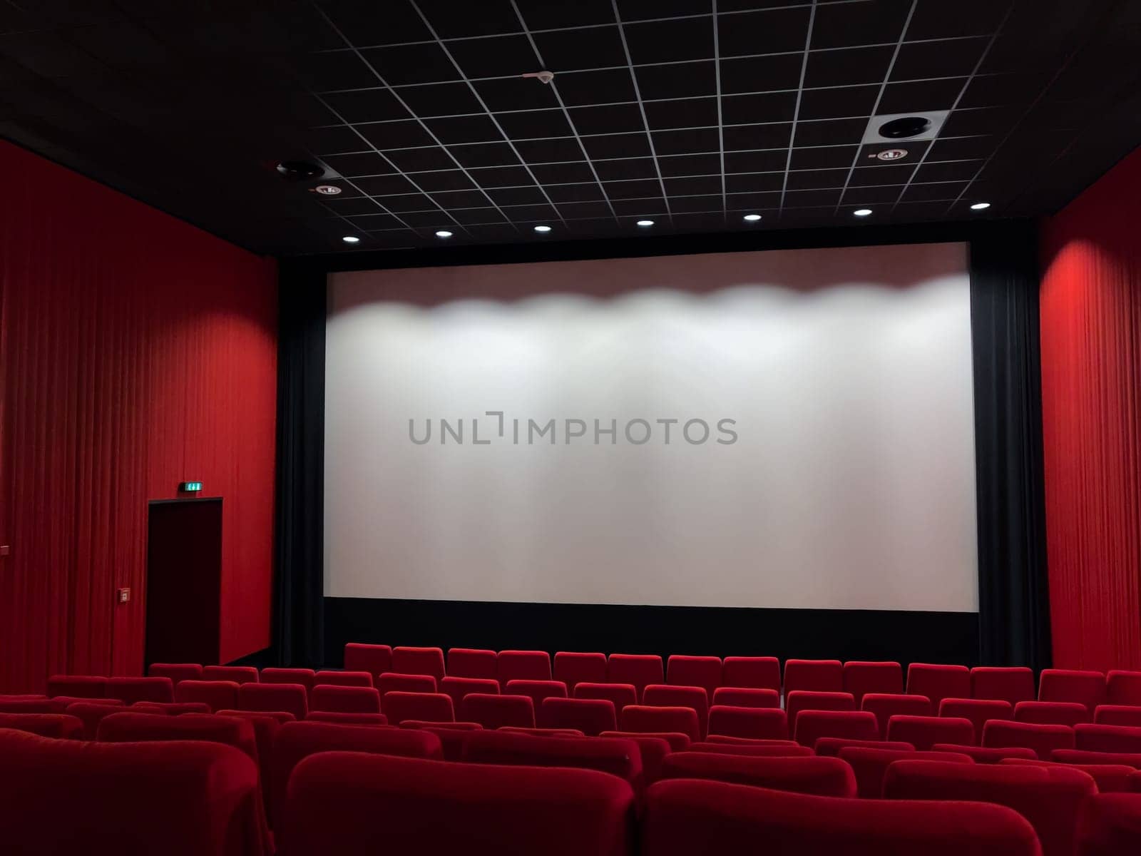 Cinema Screen  And Red Seats. Empty Screening Theater