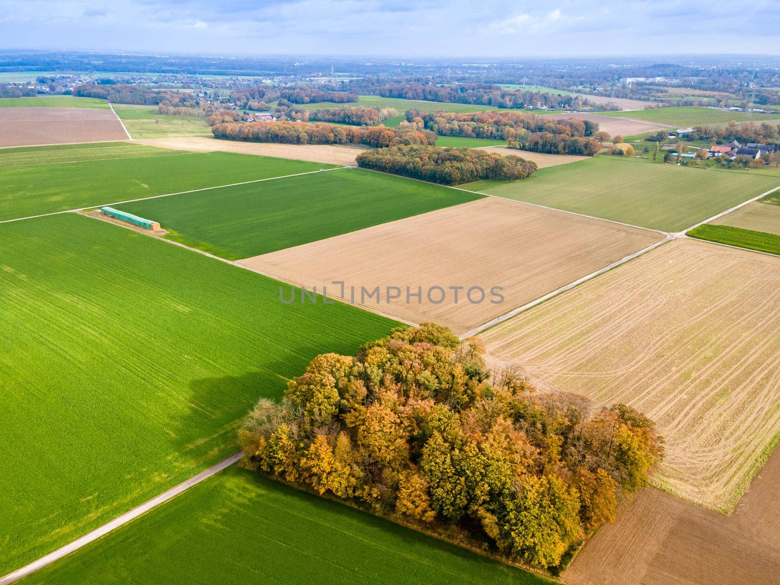 Aerial view of a  pastures and arable land. Panorama over healthy green crops in patchwork pasture farmland