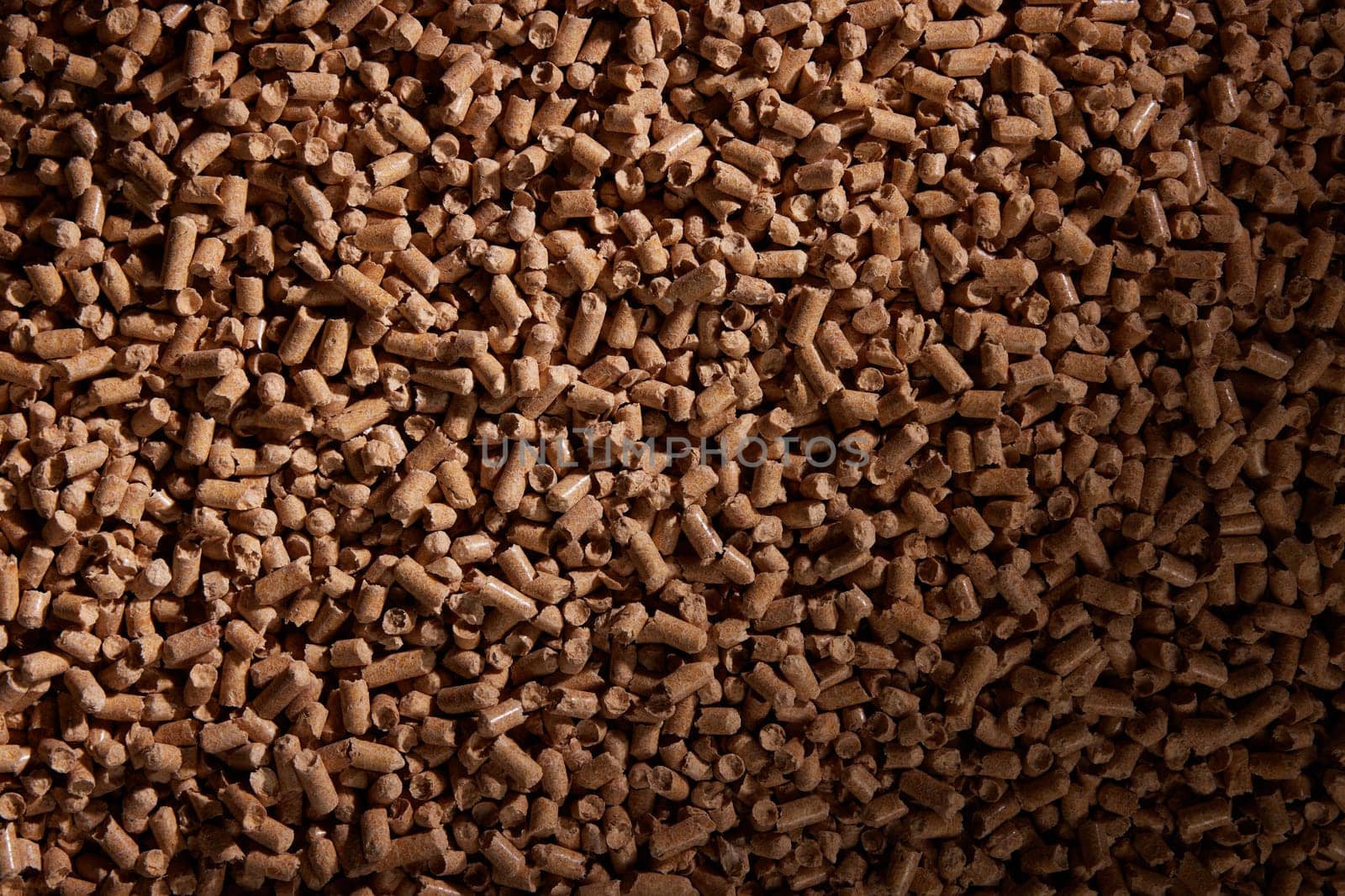 Top view full frame of pile of compressed wood pellets in daylight as abstract background