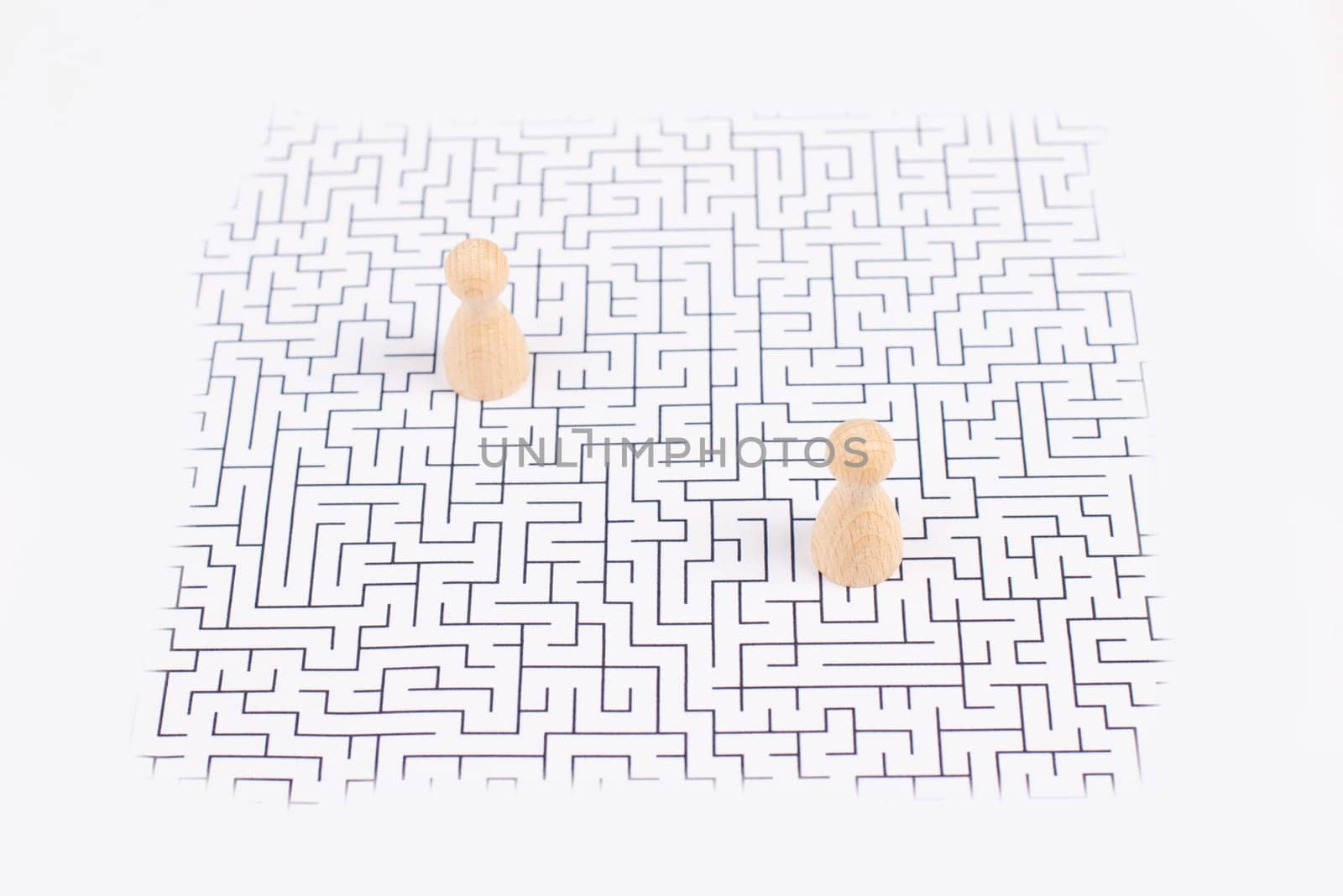 Men stand in the middle of a labyrinth, searching for a solution to exit, finding a strategy, challenge and problem solving concept