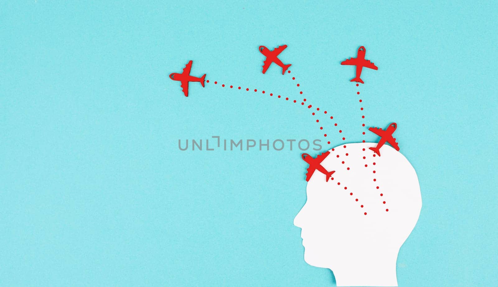 Silhouette of a head with red airplanes flying in different directions, having a vision for the future, idea for a new business, thinking outside the box, being open minded