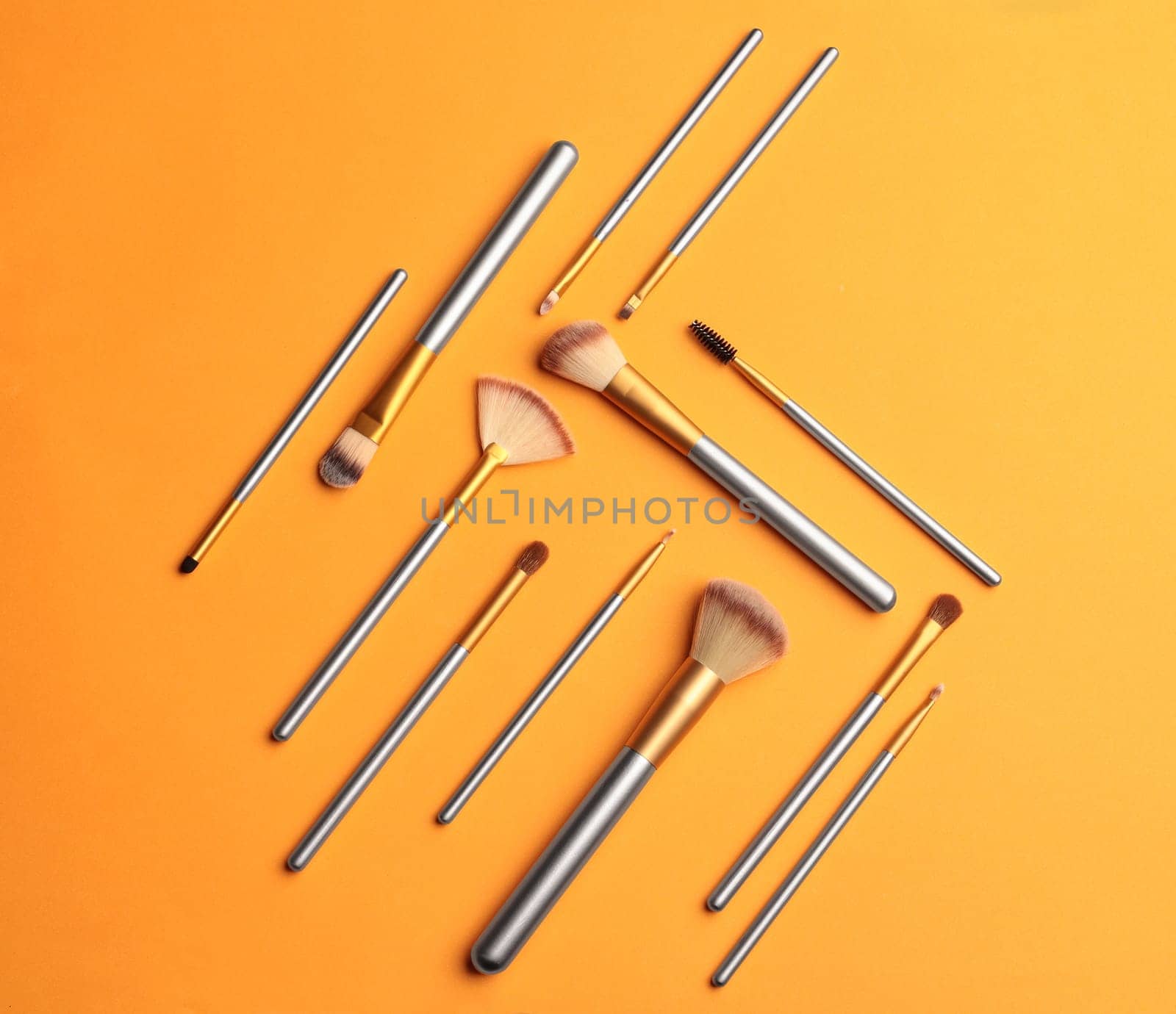 Makeup brushes over color background. Top view cosmetic image