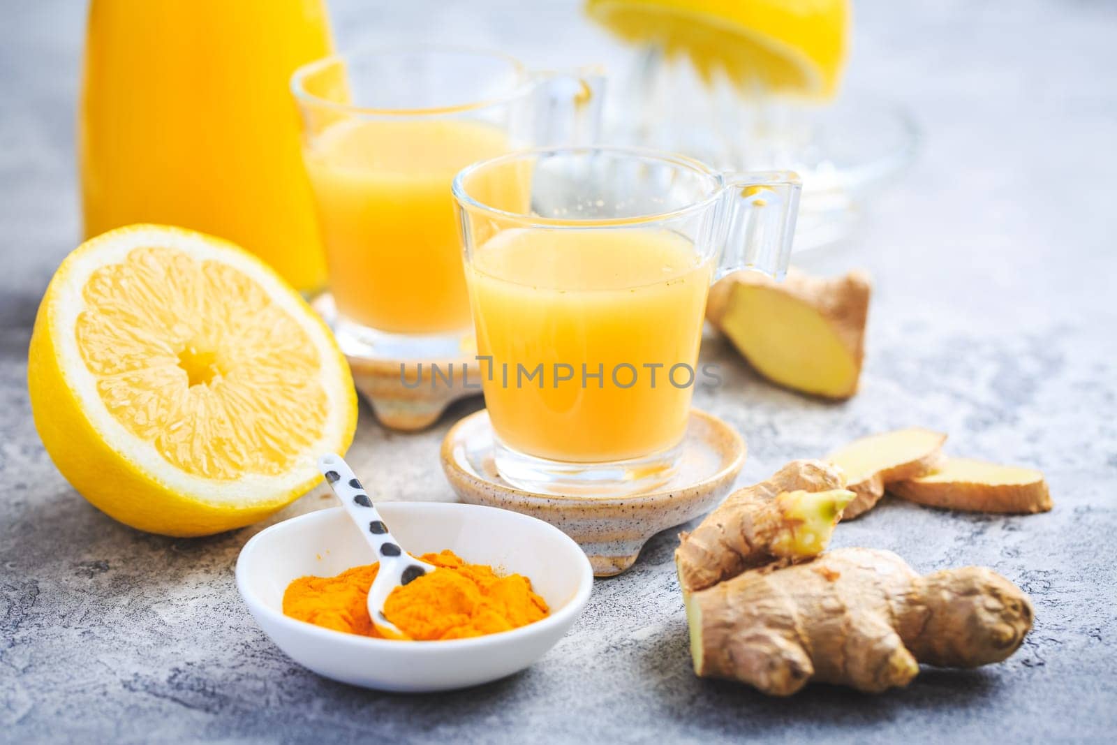 Close up of healthy Ginger Lemon Turmeric Shot – ideal to boost the immune system